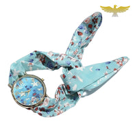 Montre foulard rose à fleurs blanches